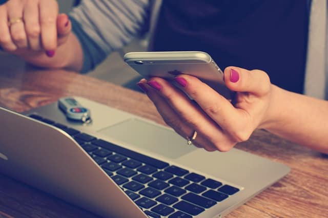 Woman holding a phone, how to protect yourself from EMF exposure