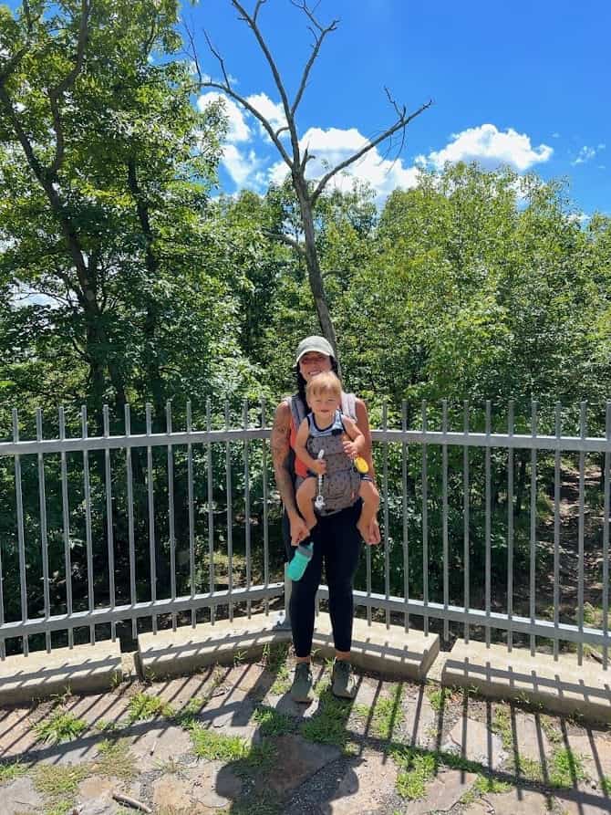 women carrying her child while hiking