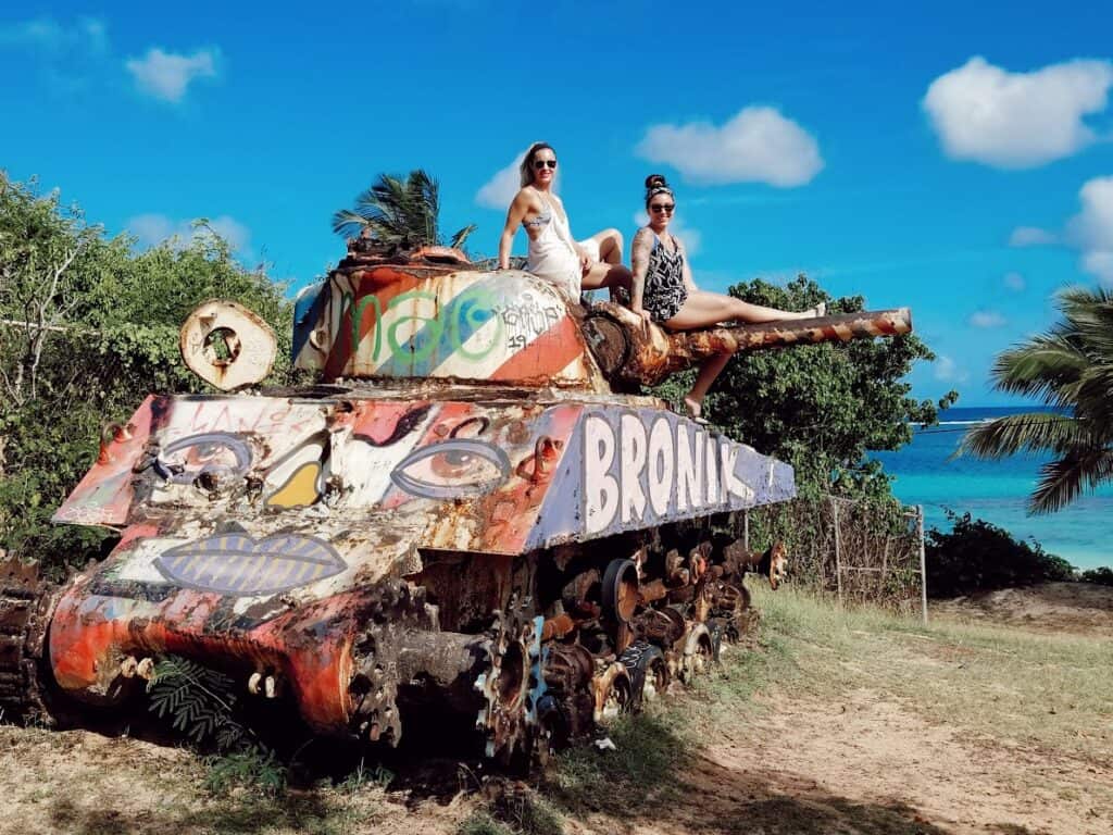 two girls posing on a tank machine