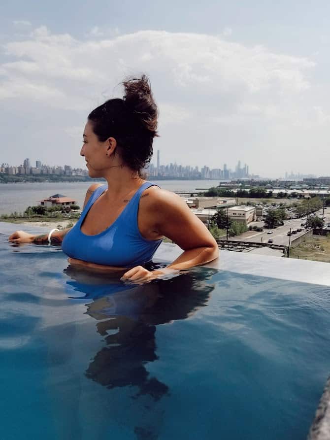 girl posing in an infinity pool