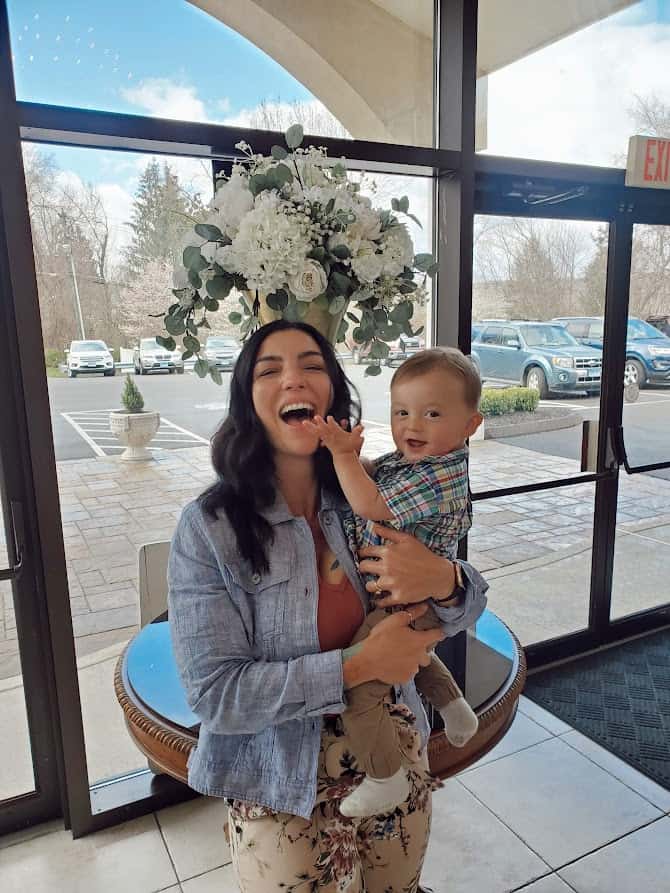 women holding her child in a banquet room