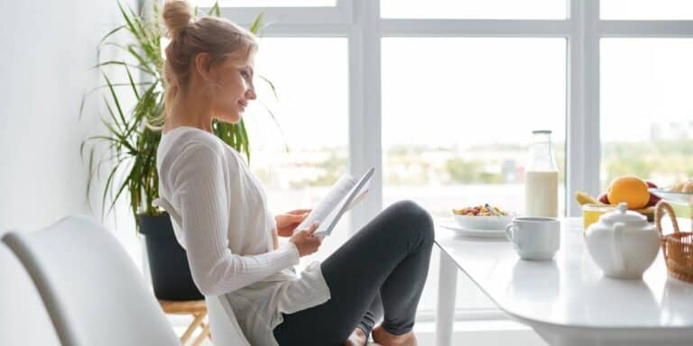 young women reading a book after a healthy breakfast